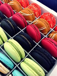 High angle view of colorful macaroons in box