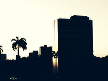 Low angle view of silhouette built structures against sky