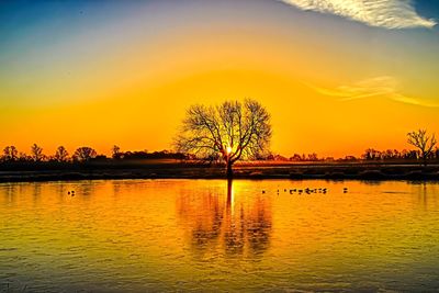 Scenic view of lake against sky during sunset