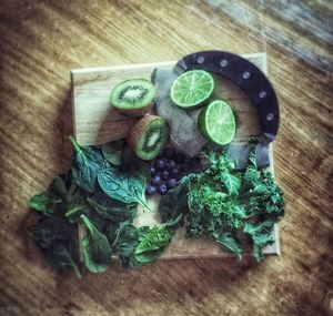 High angle view of vegetables and kiwi fruits on cutting board