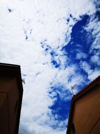 Low angle view of building against cloudy sky