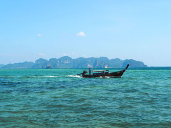 Boat sailing in sea against sky