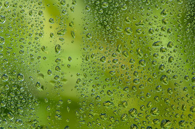 Full frame shot of wet glass window during rainy season