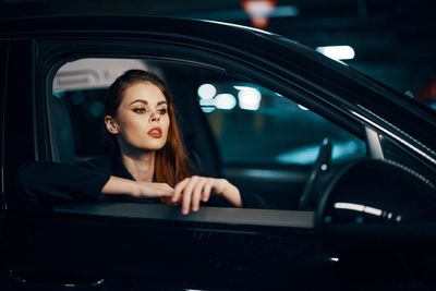 Young woman sitting in car