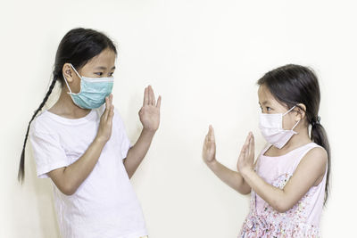 Portrait of woman standing against white background