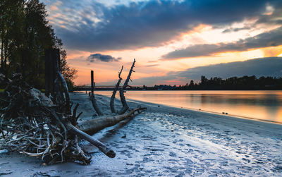 Scenic view of beach against sky during sunset