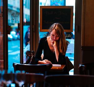 Portrait of woman sitting in restaurant