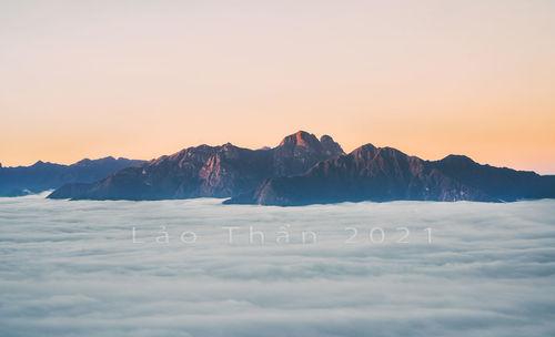 Scenic view of snowcapped mountains against sky during sunset