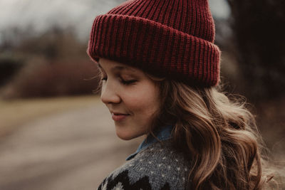 Close-up of woman with eyes closed wearing knit hat