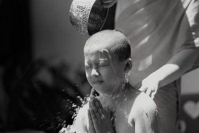 Portrait of shirtless boy in water