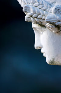 Close-up of statue against water