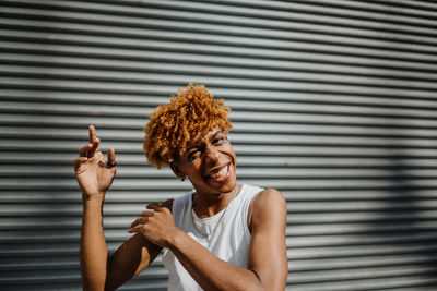 Young boy smiling and posing front of the wall at the street. copyspace