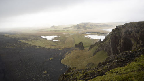 Scenic view of mountains and river against sky