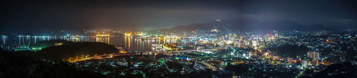 High angle view of illuminated city buildings at night