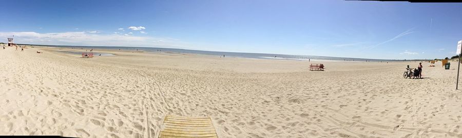 Panoramic view of beach against blue sky