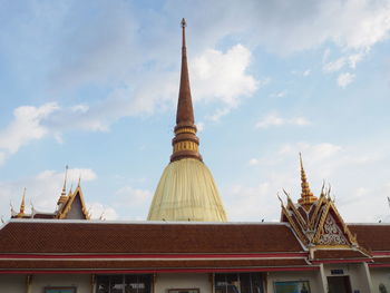 Low angle view of church against cloudy sky