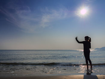 Man standing on beach against sky