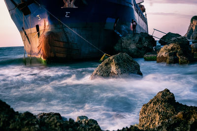 Panoramic view of rocks on sea shore against sky