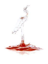 Close-up of water splashing against white background