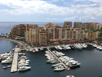 High angle view of buildings by sea against sky