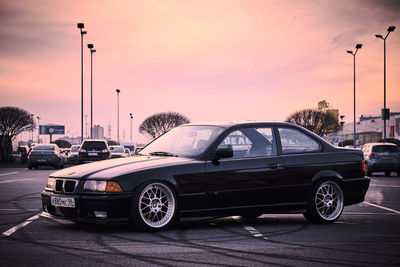 Car on street at sunset