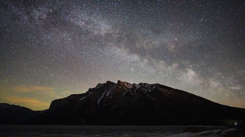 Scenic view of mountains against sky at night