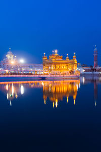 Reflection of illuminated building in water at night