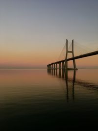 View of bridge over sea during sunset