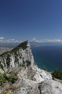 Scenic view of sea and mountains against sky