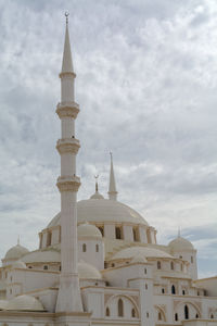 Low angle view of church against cloudy sky