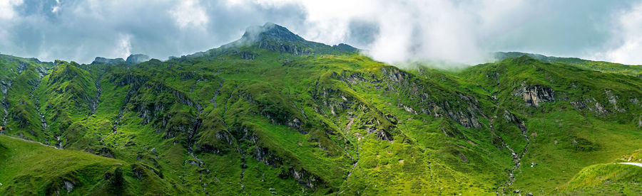 Green rocks and clouds in the austrian alps