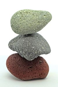 Close-up of stone on table against white background