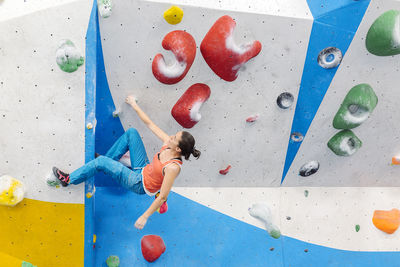 Woman climbing on wall