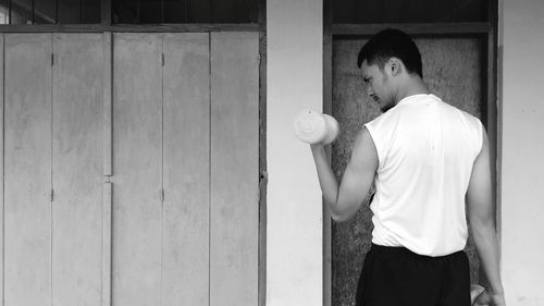 Side view of a young man holding ball