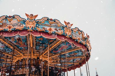 Low angle view of carousel against clear sky