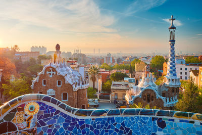 Barcelona city view from guell park. sunrise view of colorful mosaic building in park guell