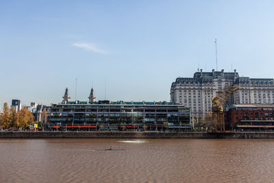 Bridge over river against buildings in city