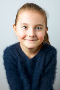 Portrait of young woman against white background