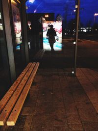 Blurred motion of people walking on illuminated road