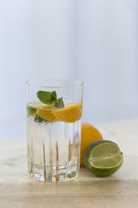 Close-up of drink and citrus fruits on table