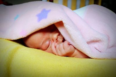 Low section of baby under blanket