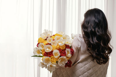 Rear view of woman with bouquet