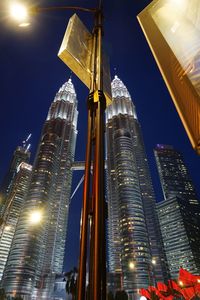 Low angle view of illuminated buildings against sky at night