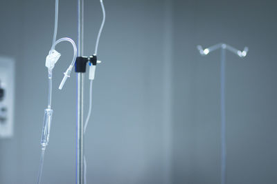 Low angle view of iv drip stands in hospital ward