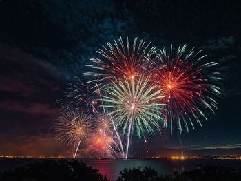 Low angle view of firework display at night