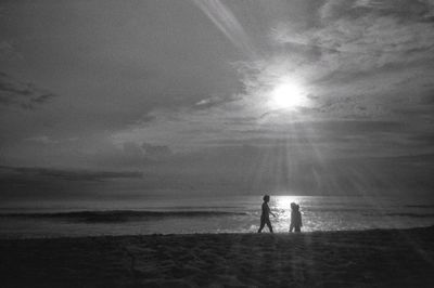 Silhouette of man standing on beach