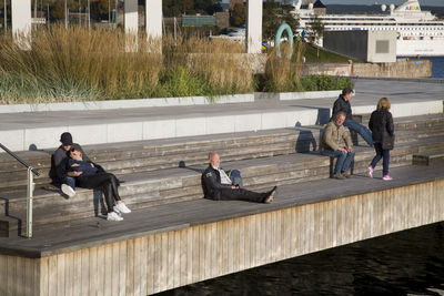 People sitting on bench in city