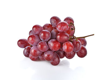 Close-up of grapes against white background