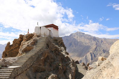 Panoramic view of buildings against cloudy sky