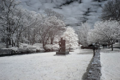Statue in park against sky during winter